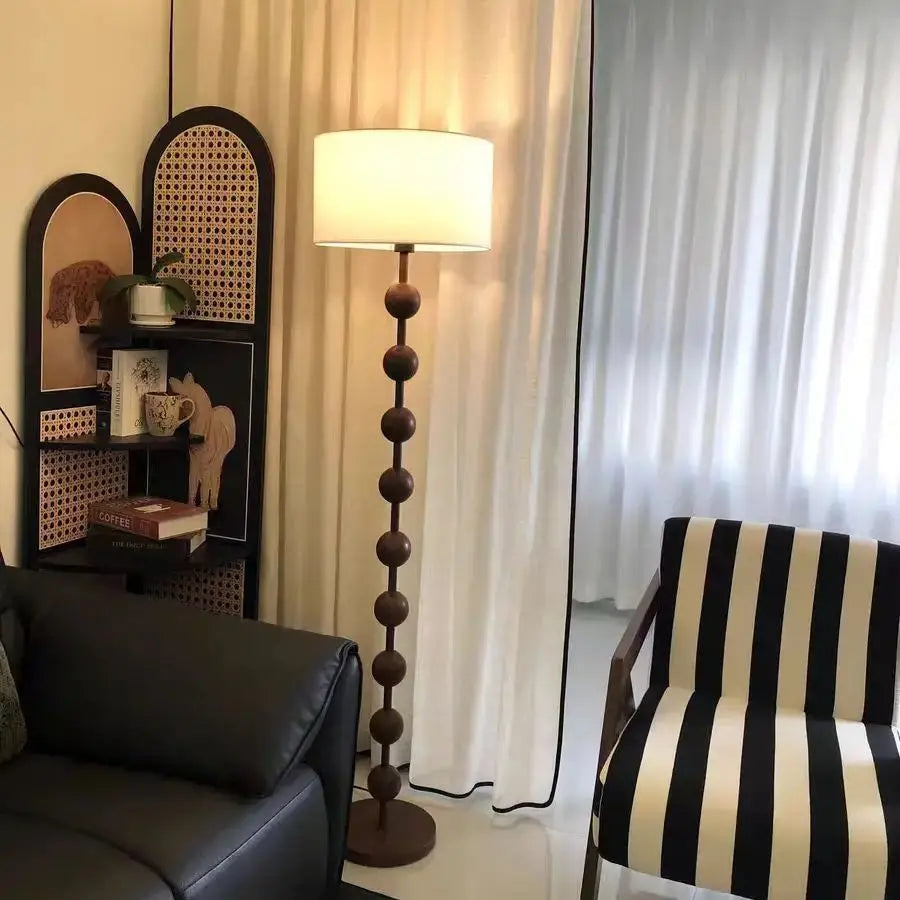 Lampadaire pied en perles de bois et abat-jour tambour – Lioux, vue d’ambiance