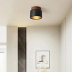 Plafonnier cylindre effet pierre de lave noire et noyer – Agde dans un intérieur