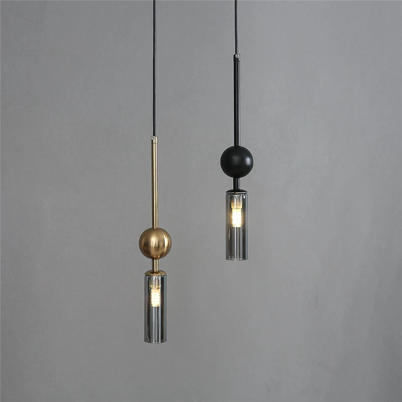 Suspension tube de verre et sphère, dorée ou noire – Montaigne, sur fond clair