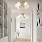 Plafonnier tiges courbes et globes opalins, 3 ou 6 lumières – Raspail dans un intérieur
