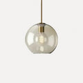 Suspension en verre cognac, cinq formes, monture laiton – Sovana, finition globe Ø 15 cm