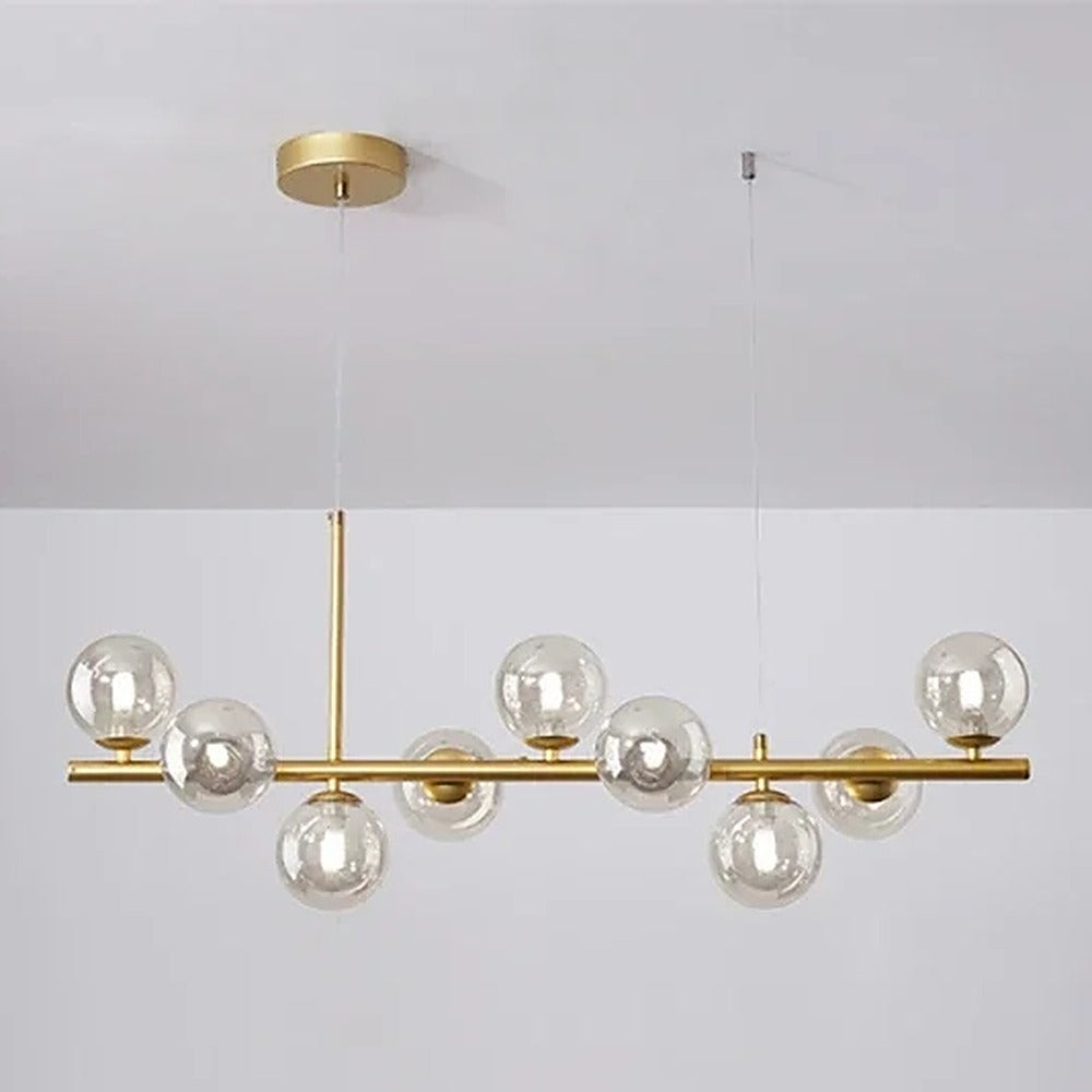 Suspension linéaire à globes de verre, noire ou dorée – Varenna, finition doré, verre transparent / 7 globes, L 65 cm
